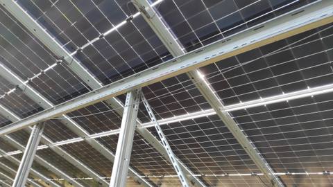 View from below of bifacial modules and the mounting structure of a ground-mounted system